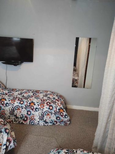 a bedroom with a bed and a flat screen tv at Edinburgh North 1 in Edinburgh