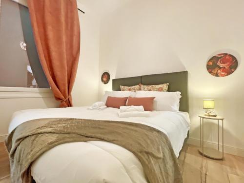a large white bed in a room with a window at Happy Family Apartments Soziglia in Genova
