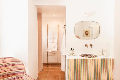 a bathroom with a sink and a mirror at Cortijo Genesis in Gaucín