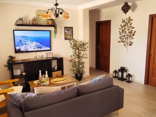 a living room with a couch and a table at Apartamento San Cristóbal Benalmádena Costa in Benalmádena