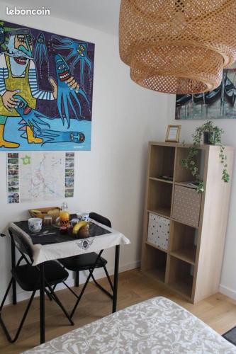 a dining room with a table and a painting on the wall at La Source 