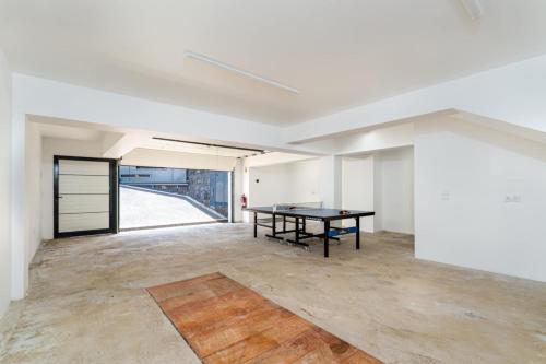 an empty room with a ping pong table in it at villa vista do vale in São Vicente