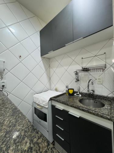 a kitchen with a sink and a counter top at STUDIO IPANEMA CONFORTÁVEL in Rio de Janeiro