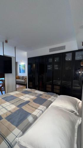 a bedroom with a large bed and a living room at רויאל שנגרילה in Eilat