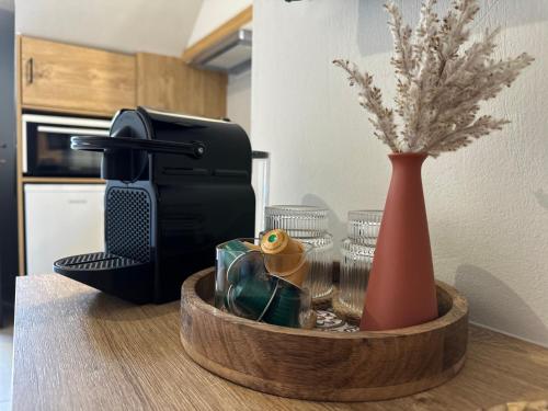 a table topped with a coffee maker and a vase at Arch Residence, studio 1, Apothika in Katarráktis