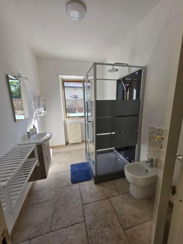 a bathroom with a glass shower and a toilet at B612 bed & breakfast CAMERE in Manoppello