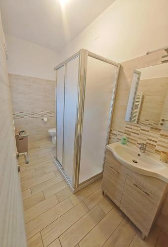 a bathroom with a shower and a sink and a toilet at Casa La Cartolina in Querceta