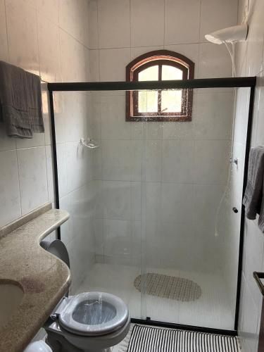 a bathroom with a shower with a sink and a toilet at Refúgio wbenthé in Paty do Alferes