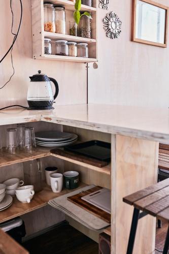a kitchen with an open cabinet with plates and utensils at Domos de Matanzas in Matanzas