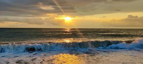 a sunset over the ocean with the waves at Gonio Horizon Apartment in Gonio