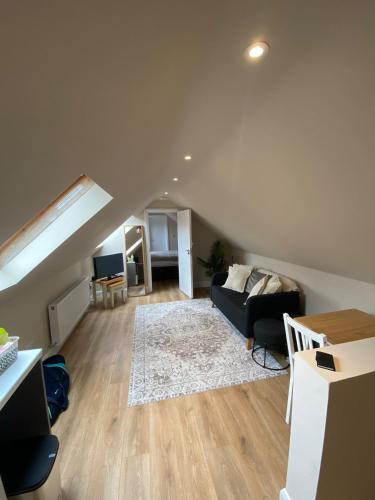 a living room with a couch and a table at The Loft in Roundwood