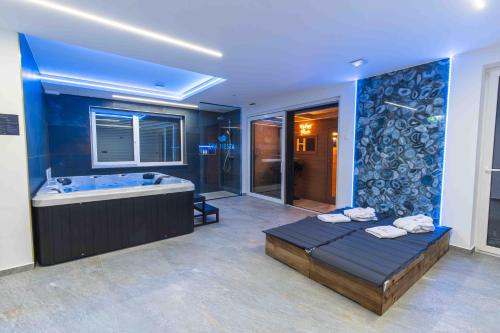 a large bathroom with a tub and a bed at New app with jacuzi, sauna & EV charging 11kW in Kranj