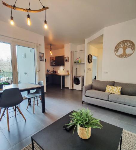 un salon avec un canapé et une table dans l'établissement Eldorado proche du lac, à Annecy