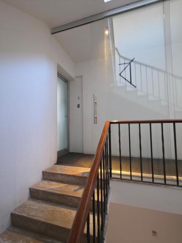 a staircase in a white building with a glass window at Marina View in Taʼ Xbiex