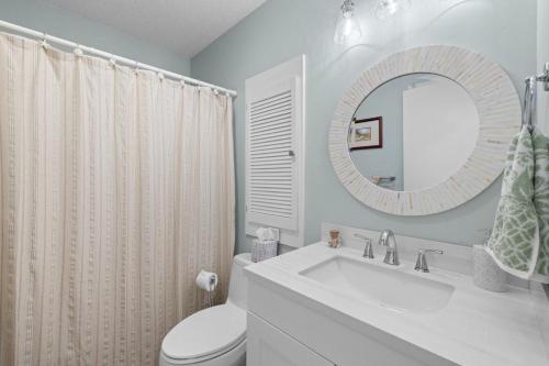a bathroom with a sink and a toilet and a mirror at Beach and Golf Adventures 3 Bedroom Sleeps 6 in Pawleys Island