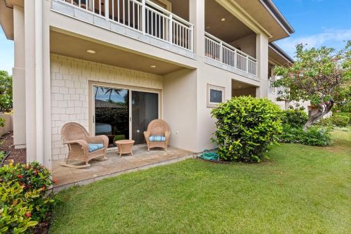 a house with two chairs and a porch at Mauna Lani Villages 606 in Waikoloa
