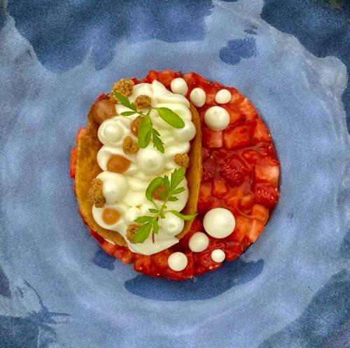 a plate with a pizza with toppings on it at Auberge du Relais d'Auniac - Hôtel Bar Restaurant Piscine in Anglars-Nozac