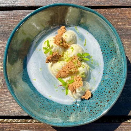 a plate of food with dumplings on a table at Auberge du Relais d'Auniac - Hôtel Bar Restaurant Piscine in Anglars-Nozac
