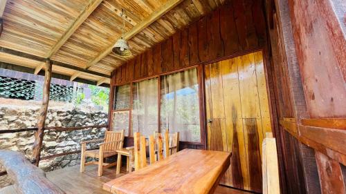 a dining room with a wooden table and chairs at El Toucanet Lodge & Restaurante in El Copey