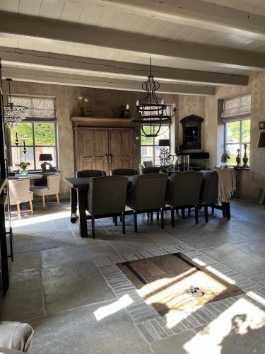 a large dining room with a table and chairs at Bed and Breakfast Lokaal Wadway in Spanbroek