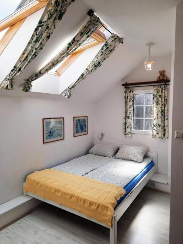 a bedroom with a bed in a attic at Agroturystyka Kaczeniec in Ustronie Morskie