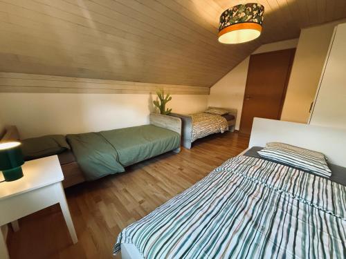 a room with two beds and a couch in it at Gîte Le 3 in Gesves