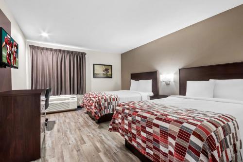 a hotel room with two beds and a television at Red Roof Inn Phoenix North - I-17 at Bell Rd in Phoenix