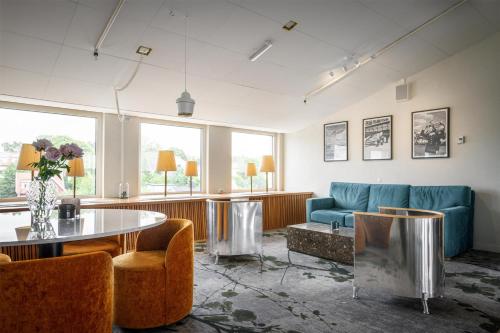 a room with a couch and a table and chairs at Best Western Plus Sthlm Bromma in Stockholm