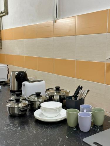 a kitchen counter with a bunch of pots and pans at Penzion Horní Bradlo in Horní Bradlo
