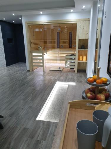 a room with a bath tub and a table with fruit at Dežman Apartments & Rooms in Kranj