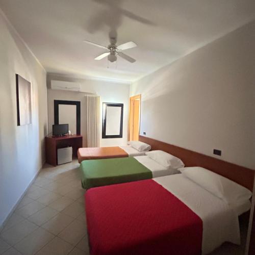 a bedroom with two beds and a ceiling fan at Caffetteria dell'Angolo in Borghetto Secondo