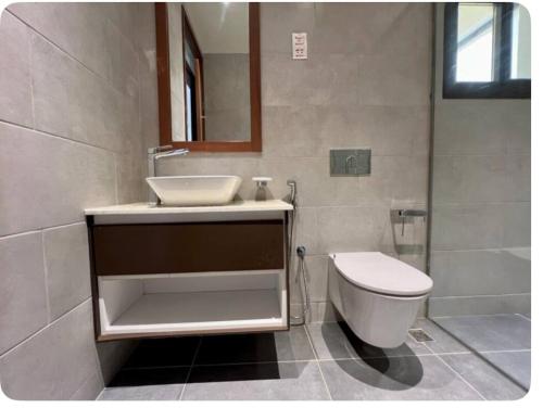 a bathroom with a sink and a toilet at Fumba Uptown Ocean Front Villa in Fumba Uwandani