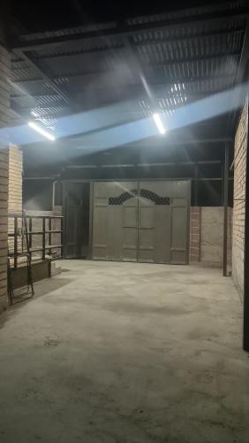 an empty garage with a large room with stalls at Домашний уют in Akchiy