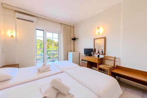 A bed or beds in a room at Artemis