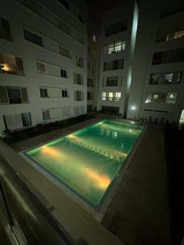 an empty swimming pool in a building at night at Plage manesmann in Mohammedia