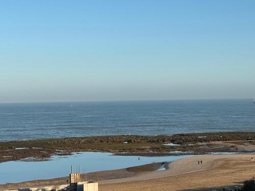 a view of a beach with a body of water at Plage manesmann in Mohammedia