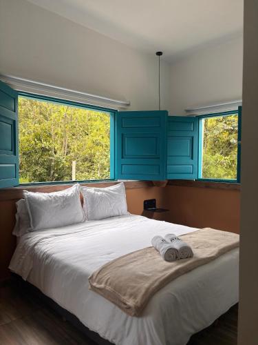 a bedroom with a large bed with blue cabinets at HotelTumbaga88 in Salento