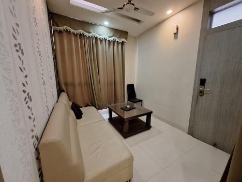 a living room with a couch and a table at Hotel Mayur Palace in Bhopal