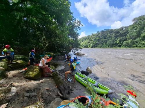 a group of people standing on the shore of a river at Pungara Eco-Lodge in Tena