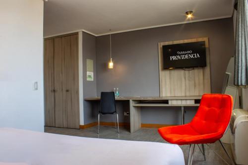 a room with a desk and a red chair at Hotel Terrado Providencia in Santiago