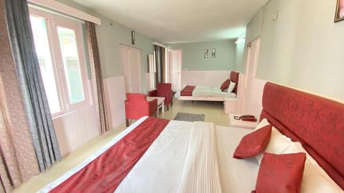 a bedroom with a bed and a living room at Hotel Ocean & Hotel Meadows Hill ! Rooftop Restaurant ! Near Hadimba Temple in Manāli