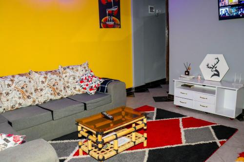 a living room with a couch and a table at AMANI 'S PLACE in Naivasha