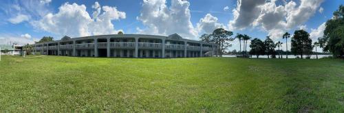 a large building on top of a green field at Budget Inn Sanford International Airport in Sanford