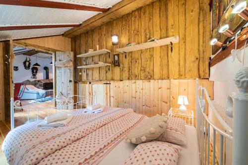 a bedroom with a bed and a wooden wall at Zruby Vila Mária Vysoké Tatry in Otilia