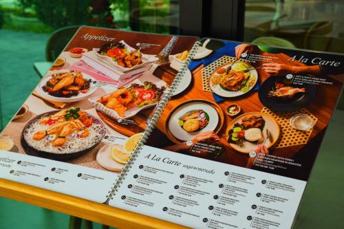 a menu for a restaurant with food on a table at The Horizon Groove Hotel in Ban Khlong
