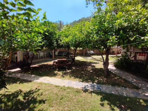 a park with a picnic table and trees at Bucak Apart Hotel Göcek & Beach in Göcek