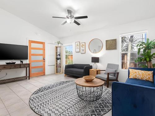 a living room with a couch and a tv at Anastasia Island Villa Upper Level plus Rooftop in Saint Augustine
