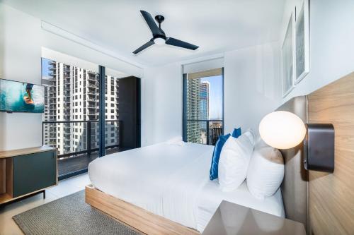 a bedroom with a white bed and large windows at Stunning 2 Bed 2 Bath w balcony & incredible views in Miami