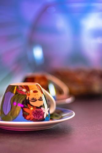 a small cup on a plate on a table at Golden Fish in Jungle Jacuzzi Sauna Sarajevo in Sarajevo