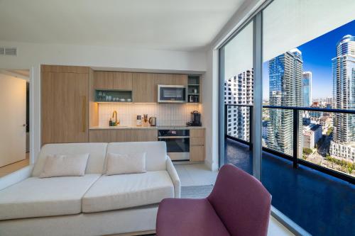a living room with a white couch and a large window at Stunning 2 Bed 2 Bath w balcony & incredible views in Miami